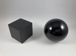 a black cube and a black shiny sphere