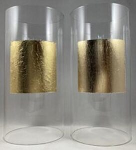 two glass tubes with a square of gold on one, imitation gold on the other